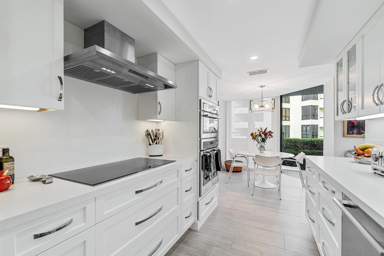 The sleek galley-style kitchen has a breakfast area at one end.