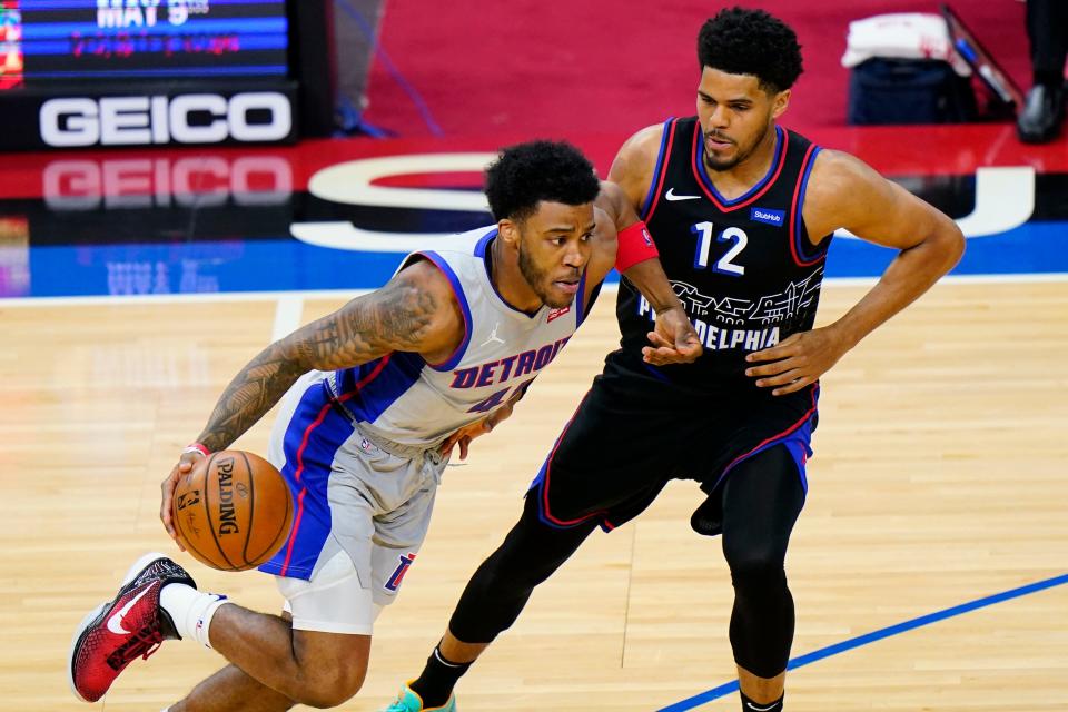 Detroit Pistons' Saddiq Bey, left, dribbles past Philadelphia 76ers' Tobias Harris during the first half of an NBA basketball game, Saturday, May 8, 2021, in Philadelphia.