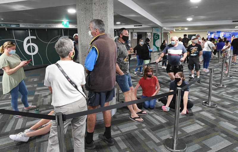 People are seen lined up to receive a vaccination for COVID-19 at the Boondall mass vaccination hub in Brisbane.