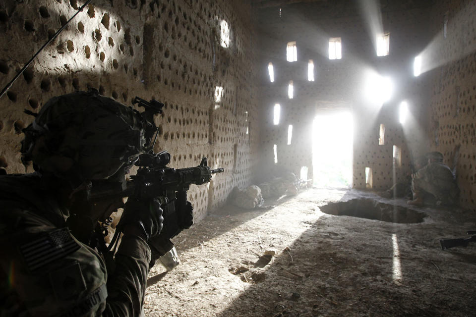 <p>U.S. soldier Nicholas Dickhut from 5-20 infantry Regiment attached to 82nd Airborne points his rifle at a doorway after coming under fire by the Taliban while on patrol in Zharay district in Kandahar province, southern Afghanistan, April 26, 2012. (Photo: Baz Ratner/Reuters) </p>