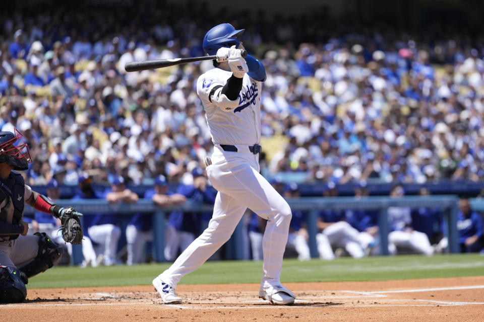 Los Angeles Dodgers designated hitter Shohei Ohtani hits home run during the first inning of a baseball game against the Atlanta Braves in Los Angeles, Sunday, May 5, 2024. Mookie Betts also scored. (AP Photo/Ashley Landis)