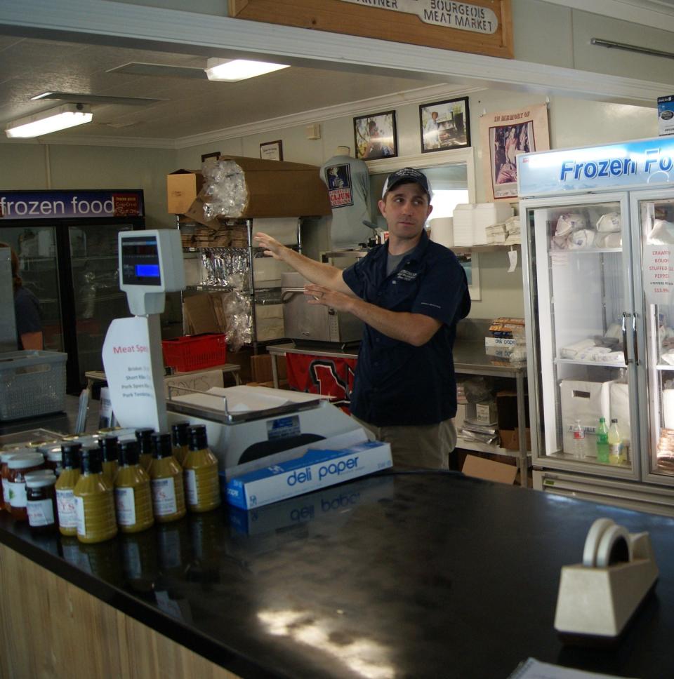 Fourth-generation owner Beau Bourgeois, 35, talks Wednesday about the work space in the current Bourgeois Meat Market in Schriever.