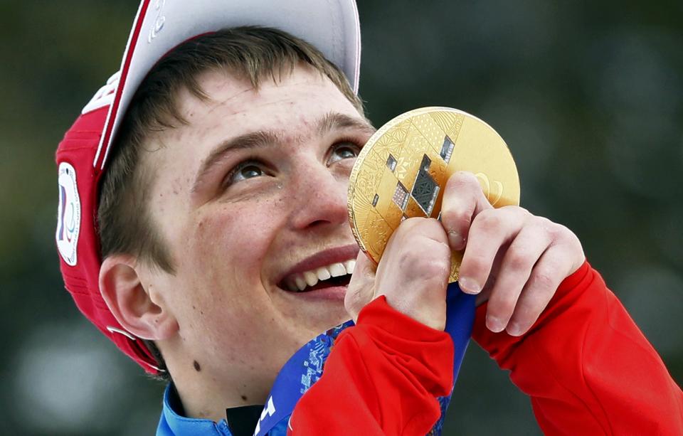 Aleksandr Pronkov, of Russia, celebrates his gold medal in the cross country men's 10km, free, standing event at the 2014 Winter Paralympic, Sunday, March 16, 2014, in Krasnaya Polyana, Russia. (AP Photo/Dmitry Lovetsky)