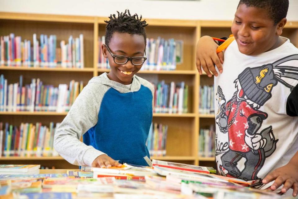 Tiras Wilson, left, and Josiah Evans pick out 10 free books from a collection donated to Wake Up and Read, which surpassed their goal of providing 110,000 books to Wake County children this year, at Walnut Creek Elementary School in Raleigh, NC, on Thursday, Jun. 27, 2019.