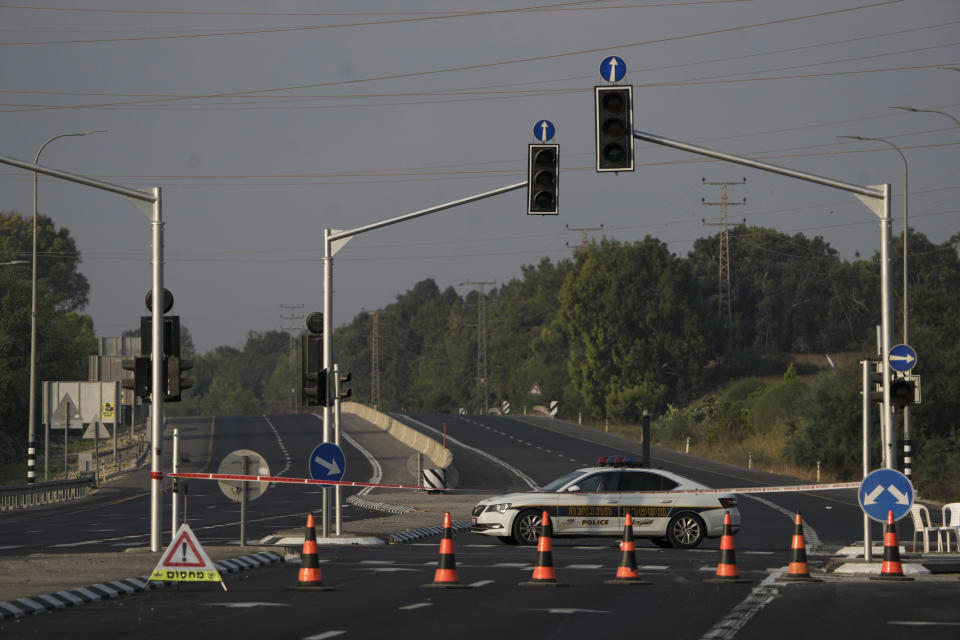 Israeli traffic police blocks a main road leading to the border with Gaza Strip, Friday, Aug. 5, 2022. The Israeli military says it is sending additional forces to the area around the Gaza Strip as it braces for possible attacks after the arrest of a senior militant in the West Bank this week. Authorities closed roads and other areas around Gaza after a raid Monday night. (AP Photo/Ariel Schalit)