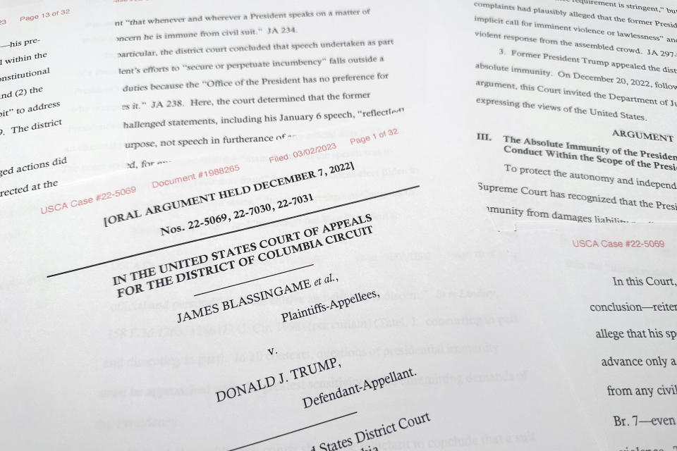 A federal court filing from the Justice Department is photographed Thursday, March 2, 2023. Former President Donald Trump can be sued by injured U.S. Capitol Police officers and Democratic lawmakers over the Jan. 6, 2021, insurrection at the U.S. Capitol, the Justice Department said in a federal court case testing Trump's legal vulnerability and the limits of executive power. (AP Photo/Jon Elswick)