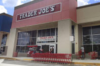 FILE - People stand in line waiting to enter Trader Joe's to buy groceries in Pembroke Pines, Fla., on March 24, 2020. Don't count on a favorite store being open on Easter Sunday. Several stores will be closed March 31, 2024, in observance of the holiday. (AP Photo/Brynn Anderson, File)