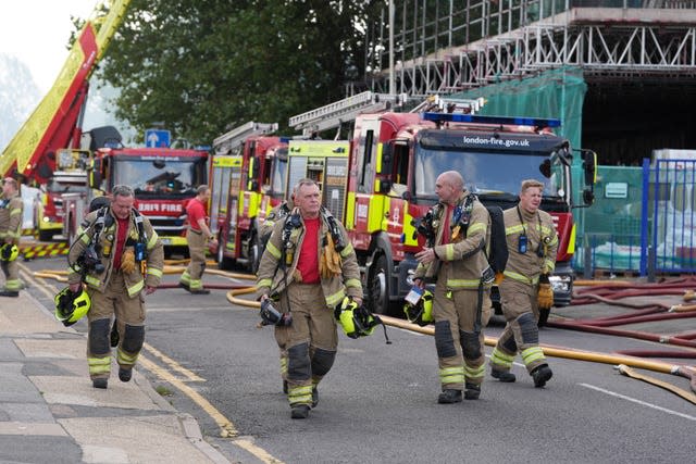 Firefighters at the scene after a blaze at a block of flats on Freshwater Road in Dagenham, East London. 