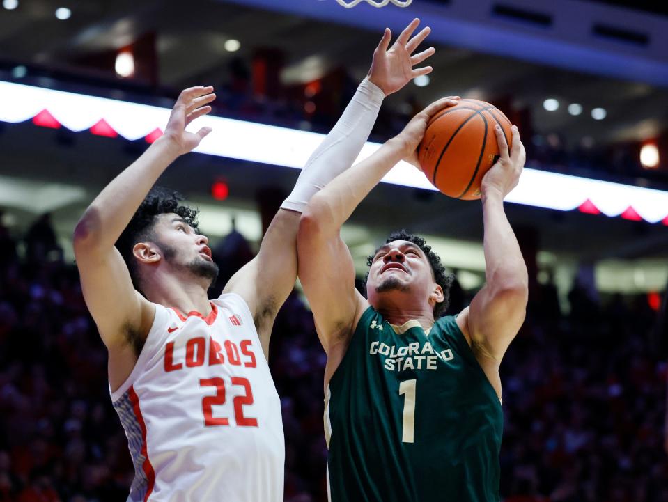 Colorado State forward Joel Scott attempts to scores under the basket as New Mexico forward Mustapha Amzil defends during the first half of an NCAA college basketball game, Wednesday, Feb. 21, 2024, in Albuquerque, N.M. (AP Photo/Eric Draper)