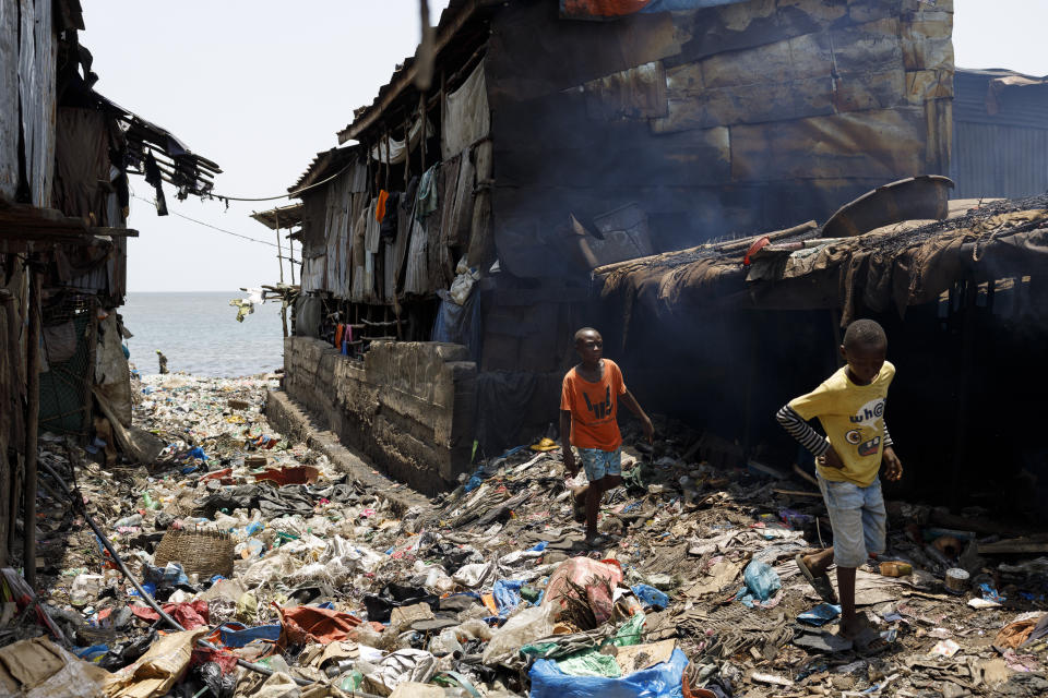 Two boys walk in Moa Wharf, a slum where Kush users live in Freetown, Sierra Leone, Friday, April 26, 2024. Sierra Leone declared a war on Kush, a cheap synthetic drug, calling it an epidemic and a national threat. The drug is ravaging youth, and healthcare services are severely limited. (AP Photo/ Misper Apawu)