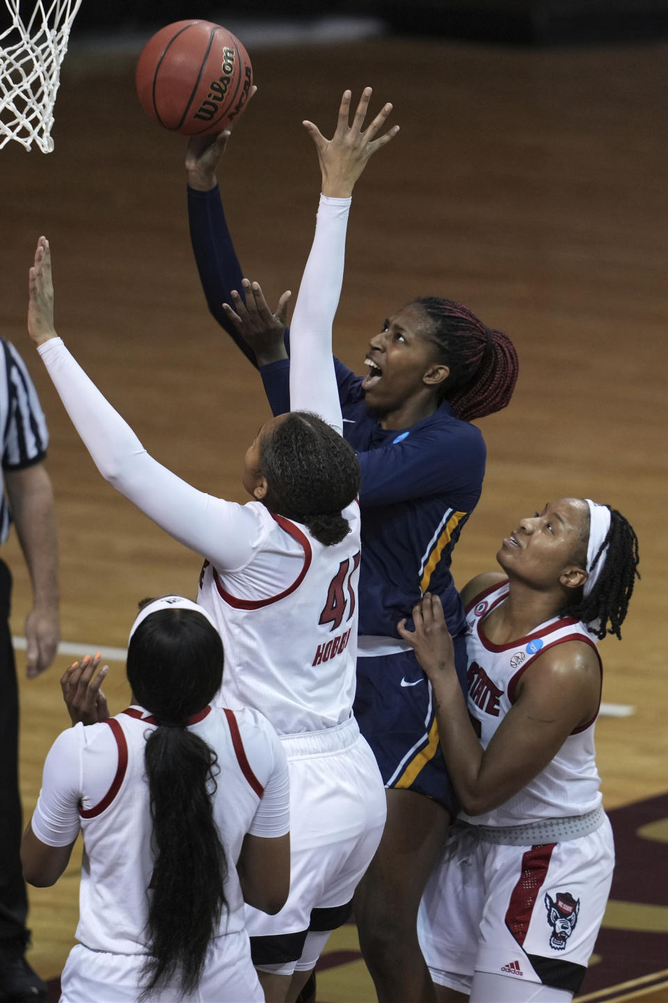 North Carolina A&T's Jayla Jones-Pack, top left, shoot against Camille Hobby (41) during the first half of a college basketball game in the first round of the women's NCAA tournament at the University Events Center in San Marcos, Texas, Sunday, March 21, 2021. (AP Photo/Chuck Burton)