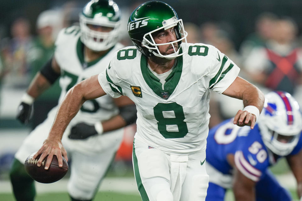 New York Jets quarterback Aaron Rodgers (8) looks to throw out of the pocket against the Buffalo Bills during the first quarter of an NFL football game, Monday, Sept. 11, 2023, in East Rutherford, N.J. (AP Photo/Seth Wenig)