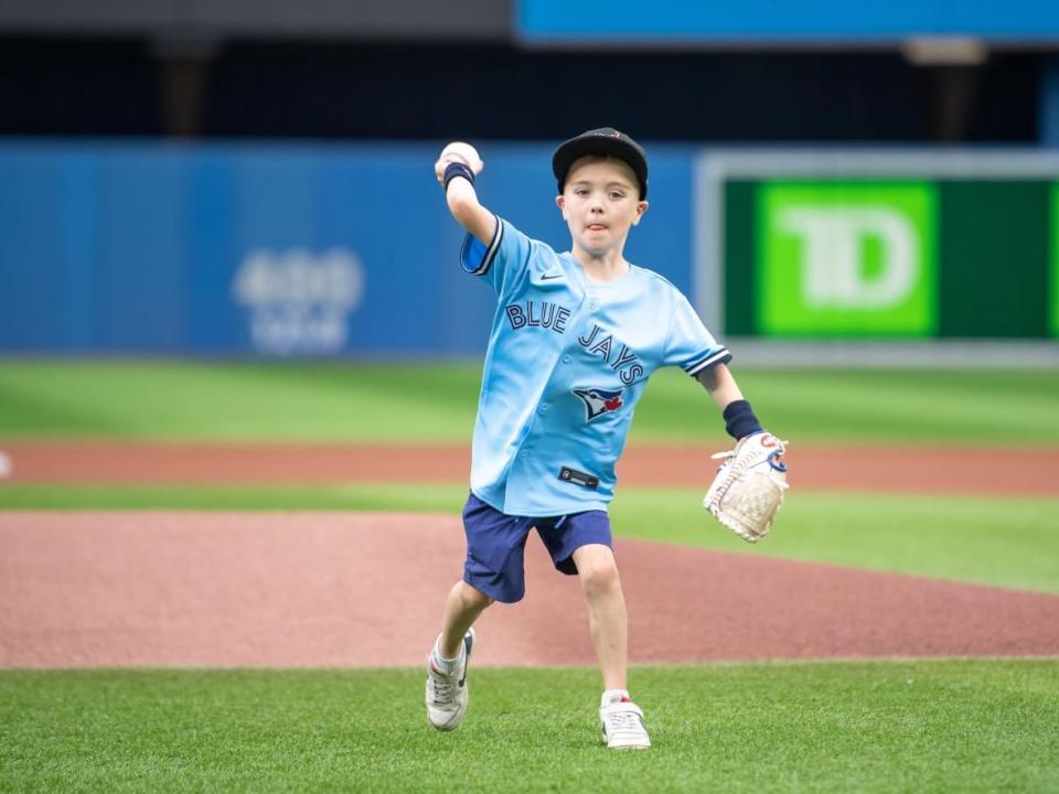 Rocky Trainor, 7, from Saskatoon got to throw the ceremonial first pitch at the Toronto Blue Jays game Tuesday. (Submitted by Toronto Blue Jays - image credit)