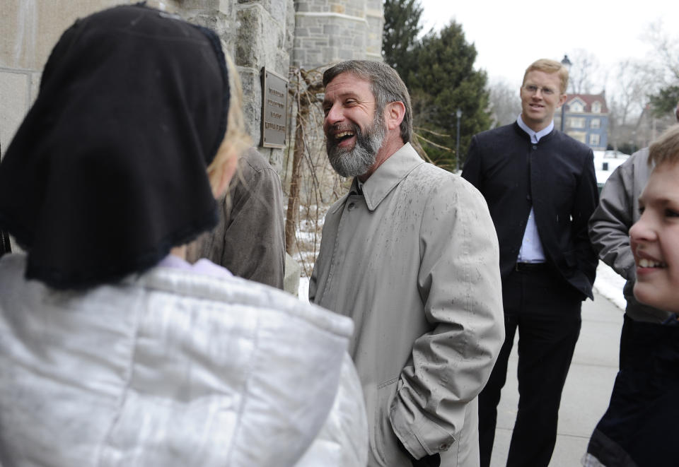 Pastor Kenneth Miller, center, stands with supporters as he waits to enter a hearing at the University of Connecticut Law School, Monday, Jan. 27, 2014, in Hartford, Conn. Miller is appealing his 2012 conviction in Vermont federal court for helping a woman and her child flee the country and avoid a custody dispute with her former lesbian partner. His 27-month prison sentence is delayed while he appeals. The New York City-based 2nd U.S. Circuit Court of Appeals are scheduled to hear cases at the University of Connecticut Law School, under an occasional practice to hold court across its territory of Connecticut, New York and Vermont. (AP Photo/Jessica Hill)