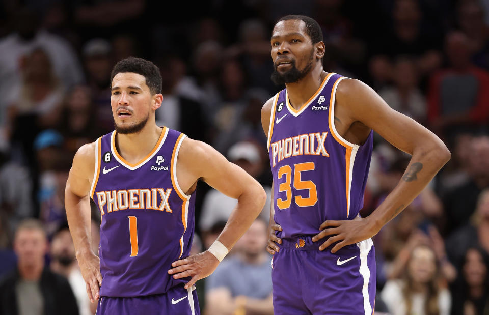 PHOENIX, ARIZONA - MARCH 29: Devin Booker #1 and Kevin Durant #35 of the Phoenix Suns stand on the court during a timeout form the second half of the NBA game against the Minnesota Timberwolves at Footprint Center on March 29, 2023 in Phoenix, Arizona. The Suns defeated the Timberwolves 107-100.  NOTE TO USER: User expressly acknowledges and agrees that, by downloading and or using this photograph, User is consenting to the terms and conditions of the Getty Images License Agreement.  (Photo by Christian Petersen/Getty Images)