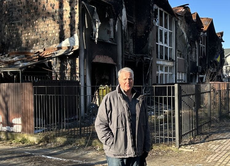 Ody Norkin of Okemos stands outside homes that were bombed in Irpin, near Kyiv, in Ukraine.