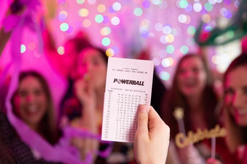 Women celebrate Powerball jackpot win.