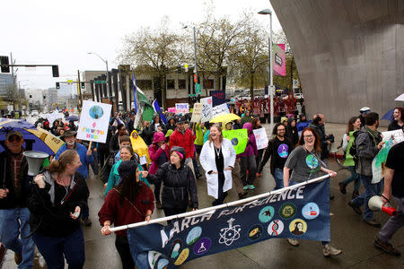 Protestors share a laugh during the March For Science in Seattle, Washington, U.S. April 22, 2017. REUTERS/David Ryder