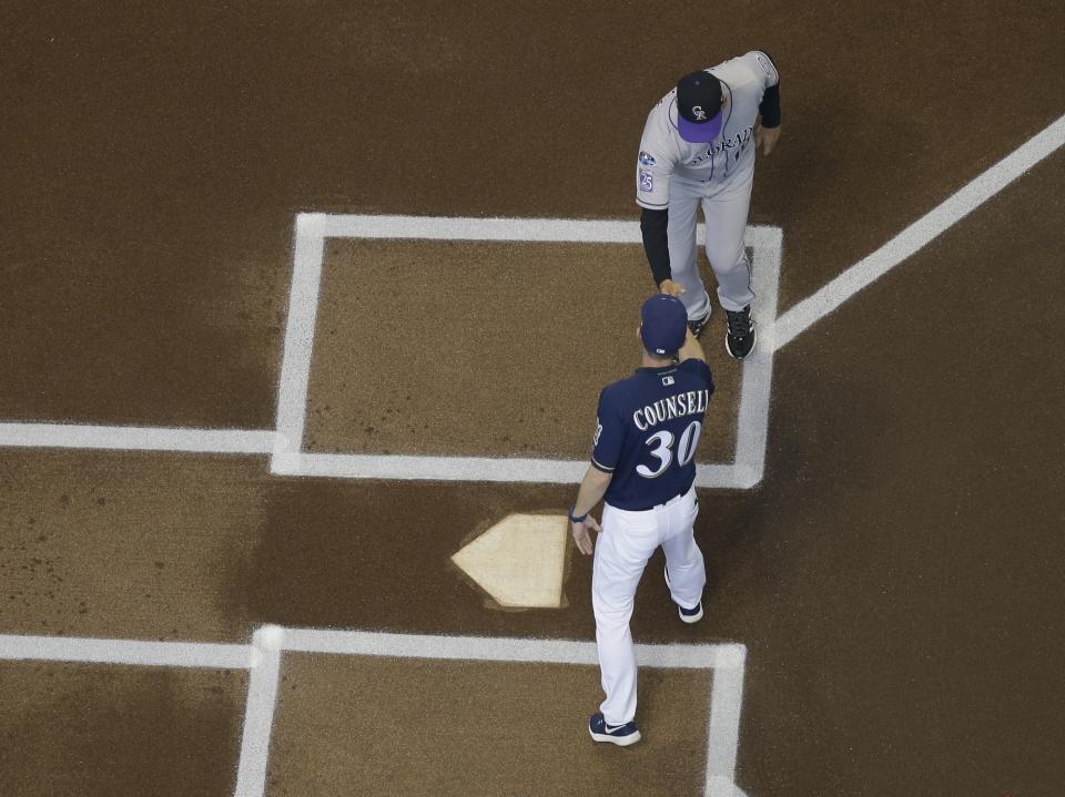 Milwaukee Brewers manager Craig Counsell shakes hands with Colorado Rockies manager Bud Black before Game 1 of the National League Divisional Series baseball game Thursday, Oct. 4, 2018, in Milwaukee. (AP Photo/Morry Gash)