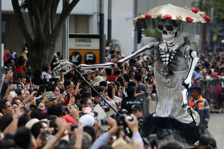 A skull figure is seen during a procession to commemorate Day of the Dead in Mexico City, Mexico, October 28, 2017. REUTERS/Edgard Garrido