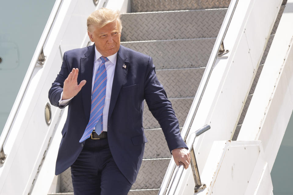 President Donald Trump waves as he arrives at Midland International Air and Space Port on Wednesday, July 29, 2020, in Midland, Texas. (Ben Powell/Odessa American via AP)