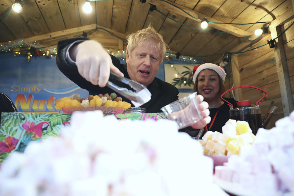 Boris Johnson gets to work at a Christmas market in Salisbury.