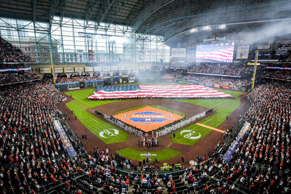 Smoke clears as the national anthem is played before the Houston Astros' season-opening baseball game against the Chicago White Sox on Thursday, March 30, 2023, in Houston. (Brett Coomer/Houston Chronicle via AP)