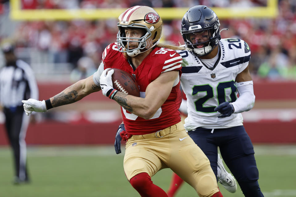 San Francisco 49ers tight end George Kittle (85) runs past Seattle Seahawks safety Julian Love (20) to score during the second half of an NFL football game in Santa Clara, Calif., Sunday, Dec. 10, 2023. (AP Photo/Josie Lepe)