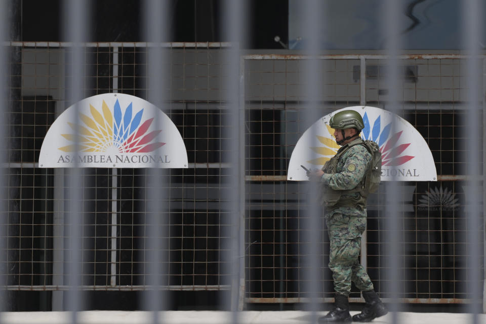 A soldier stands guard outside the National Assembly the day after the body was disolved by President Guillermo Lasso in Quito, Ecuador, Thursday, May 18, 2023. Lawmakers were moving forward with impeachment proceedings against the president on embezzlement charges when he disolved it, and now residents are expected to elect a new president and a new lawmakers in no more than 90 days. (AP Photo/Dolores Ochoa)