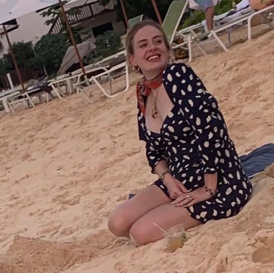 Adele sitting on the beach