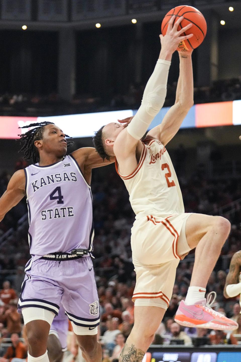Kansas State guard Dai Dai Ames, left, fouls Texas Longhorns guard Chendall Weaver on a drive to the basket late in Texas' 64-59 win Monday at Moody Center. Ames got ejected for the flagrant foul and Texas went on to get a needed Big 12 win.