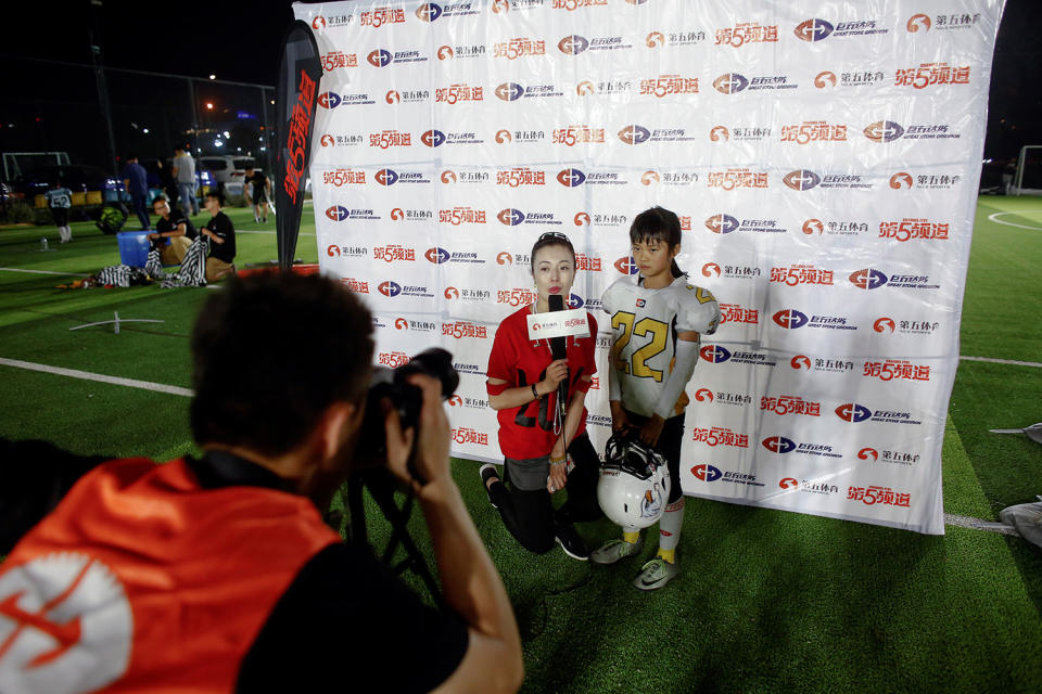 <p>Lisa Li, 9, of the Eagles gives a post-game interview after her team defeated the Sharklets in their Future League American football youth league match in Beijing, May 26, 2017. (Photo: Thomas Peter/Reuters) </p>