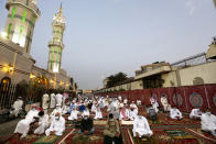 Muslims wearing masks and keeping social distancing to curb the spread of coronavirus outbreak, perform an Eid al-Fitr prayer marking the end of the holy fasting month of Ramadan at al-Mirabi Mosque in Jiddah, Saudi Arabia, Thursday, May 13, 2021. (AP Photo/Amr Nabil)