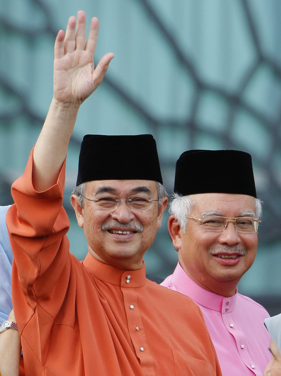 FILE - Malaysia's former Prime Minister Abdullah Ahmad Badawi, left, waves as new Prime Minister Najib Razak smile behind at Prime Minister office in Putrajaya, April 3, 2009. Najib Razak on Tuesday, Aug. 23, 2022 was Malaysia’s first former prime minister to go to prison -- a mighty fall for a veteran British-educated politician whose father and uncle were the country’s second and third prime ministers, respectively. The 1MDB financial scandal that brought him down was not just a personal blow but shook the stranglehold his United Malays National Organization party had over Malaysian politics. (AP Photo/Vincent Thian)