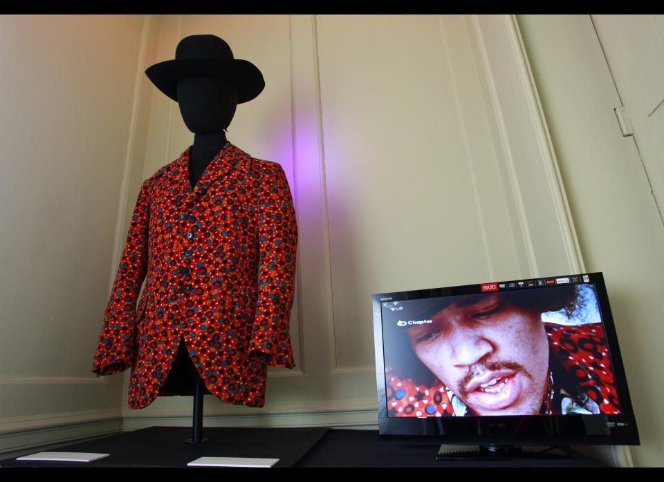 The orange velvet jacket and a black Westerner hat.    AP Photo/Lefteris Pitarakis