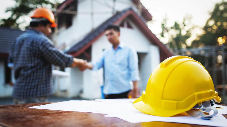 Shaking hands of partnership agreement between structural engineers and contractors to build houses.