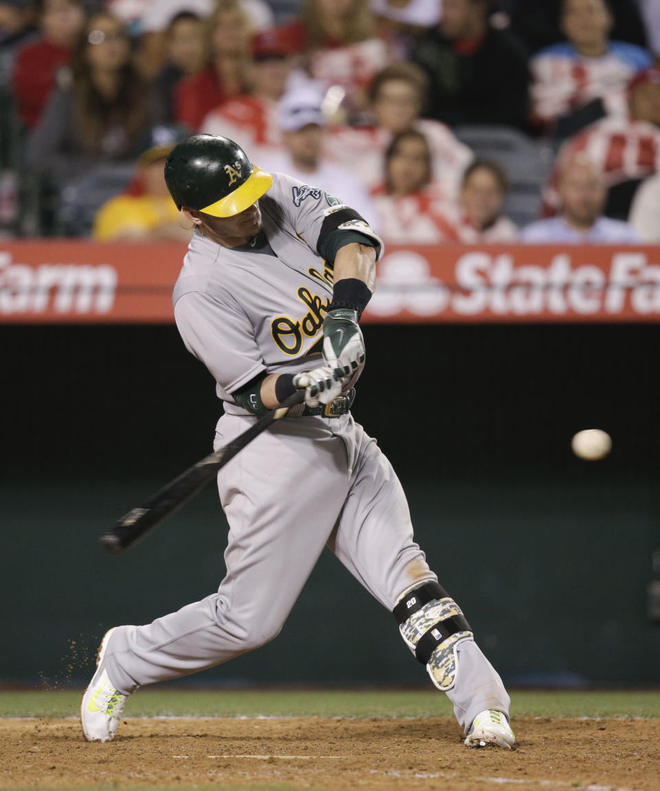 Oakland Athletics' Josh Donaldson hits a RBI-double during the 11th inning of a baseball game against the Los Angeles Angels on Tuesday, April 15, 2014, in Anaheim, Calif. (AP Photo/Jae C. Hong)