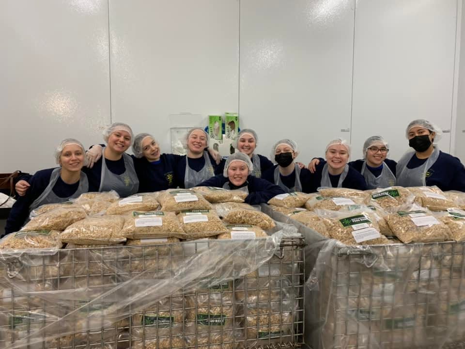 MYCA cadets perform community service at a local food bank. The last class which graduated over the summer performed more than 4,400 hours of community service to help individuals and organizations.