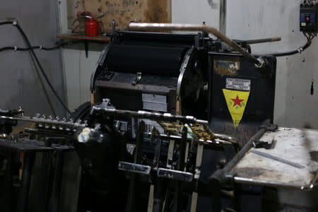 A Kurdish People's Protection Units (YPG) logo is seen on a machine at a printing press in Qamishli, Syria, March 6, 2019. REUTERS/Issam Abdallah/Files