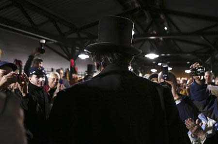 A re-enactor portraying former U.S. President Abraham Lincoln (C) is welcomed at the Gettysburg, Pennsylvania train station November 18, 2013. REUTERS/Gary Cameron