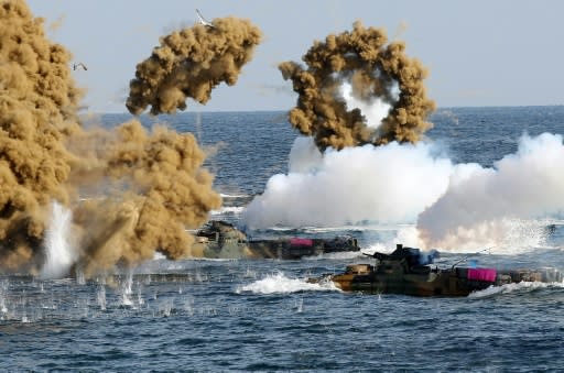 South Korean Marine amphibious assault vehicles fire smoke shells during a landing operation in the southern city of Pohang