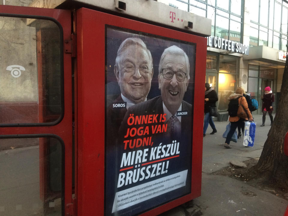 FILE - In this Feb. 19, 2019 file photo, a phone box displays a billboard showing Hungarian-American financier George Soros and EU Commission President Jean-Claude Juncker above the caption "You have a right to know what Brussels is preparing to do!", in Budapest, Hungary. Battle lines are drawn between anti-EU populist forces and traditional parties at the beginning of a three-month election campaign that could turn into a tipping point in postwar European history. The May 2019 EU elections has already produced unprecedented abrasive campaigning. (AP Photo/Pablo Gorondi, File)