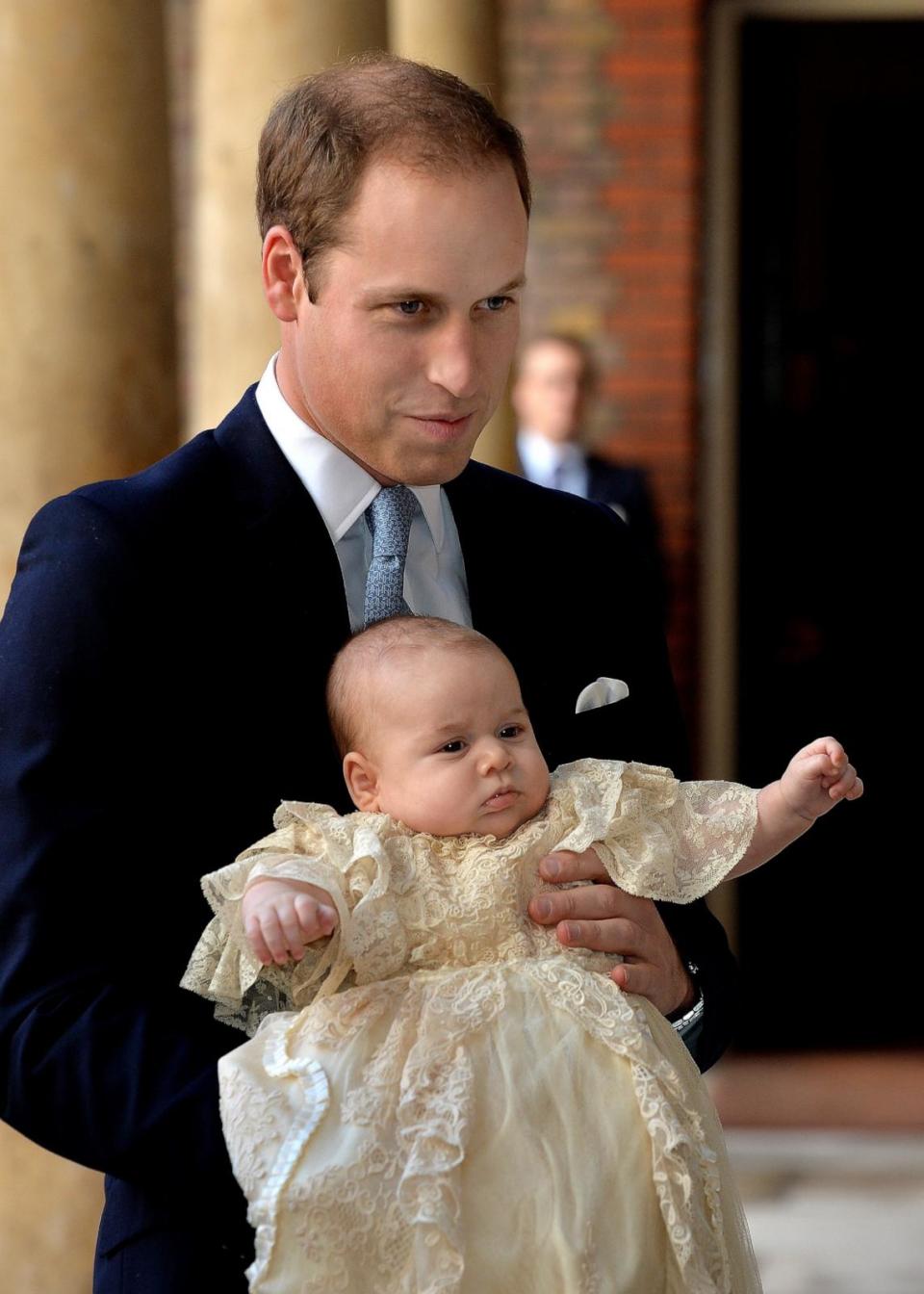 PHOTO: Prince William, Duke of Cambridge arrives, holding his son Prince George, at Chapel Royal in St James's Palace, ahead of the christening of the three month-old Prince George of Cambridge by the Archbishop of Canterbury, Oct. 23, 2013, in London. (John Stillwell/WPA Pool/Getty Images)