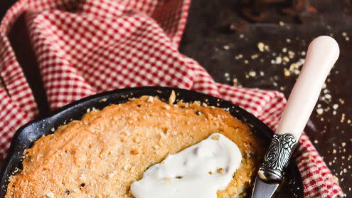giant chocolate chip cookie or chocolate chip cookie pizza baked in the oven in the iron cast pan served with vanilla cream cheese on a wooden table, selective focus sweet food american food