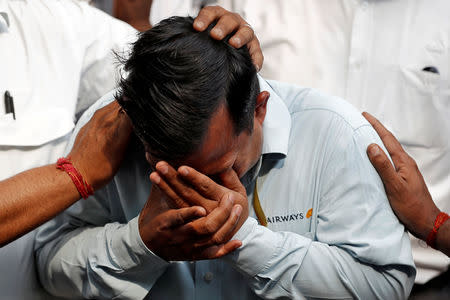 An employee of Jet Airways is consoled by his colleagues during a protest demanding to "save Jet Airways" in New Delhi, India, April 18, 2019. REUTERS/Adnan Abidi