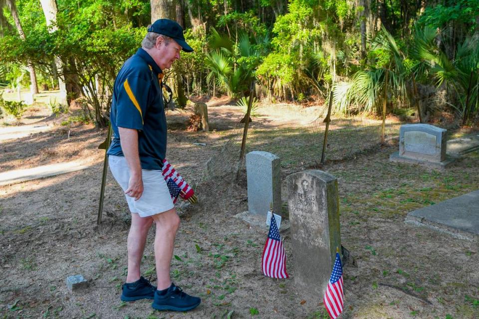 U.S. Army Col. Donald Dawson (ret.) with Bluffton’s Dennis J. Becker American Legion Post 205, places American flags at gravestones at the Bluffton Cemetery on Friday, May 14, 2024 for Memorial Day. The legion also placed flags at Sauls Funeral home’s Lowcountry Memorial Gardens and Jaxville Cemetery.