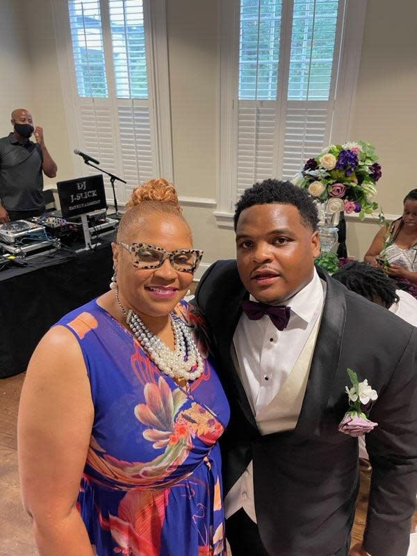 Casaundra Eddins, left, with her son Chancellor Eddins at a friend's wedding in 2021. Seven months after Chancellor's slaying, the family is still waiting for answers in the case.