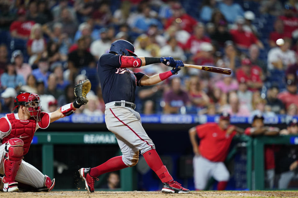 Washington Nationals' Luis Garcia hits a two-run double against Philadelphia Phillies pitcher Aaron Nola during the seventh inning of a baseball game, Wednesday, July 6, 2022, in Philadelphia. (AP Photo/Matt Slocum)