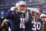 New England Patriots running back Damien Harris, right, celebrates with quarterback Mac Jones, left, after his touchdown during the second half of an NFL football game against the Tennessee Titans, Sunday, Nov. 28, 2021, in Foxborough, Mass. (AP Photo/Mary Schwalm)