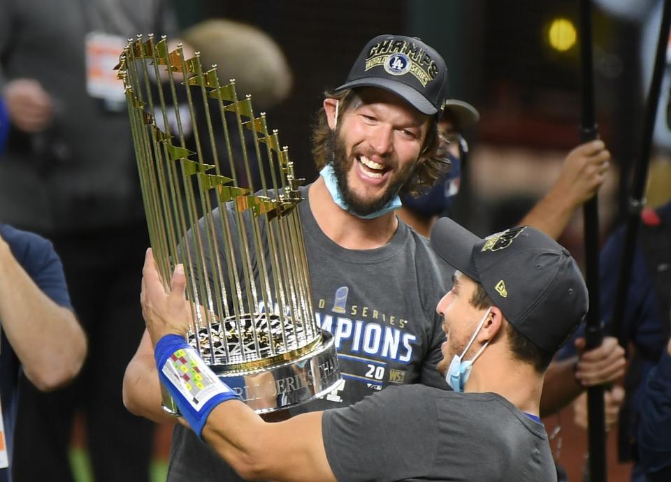 Dodgers Clayton Kershaw, left, and Austin Barnes hold the Championship trophy in Game 6